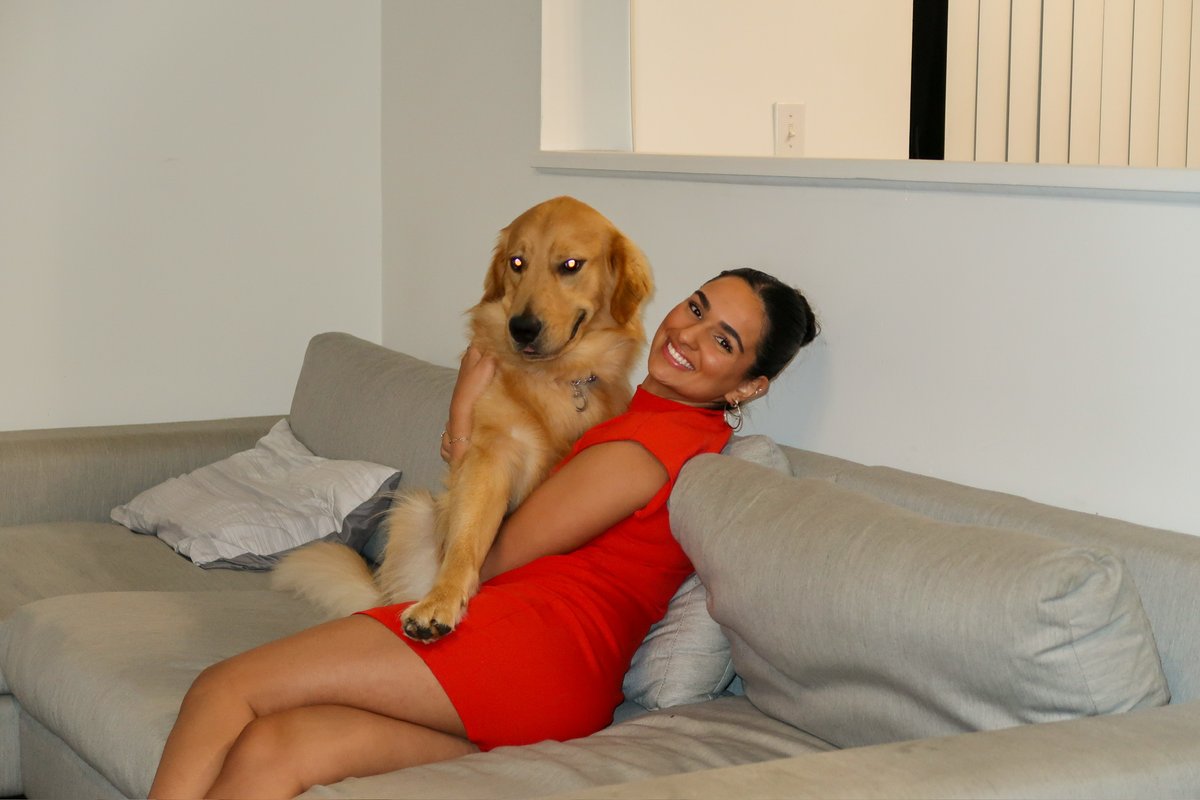 Isabella relaxing on the couch with a golden retriever